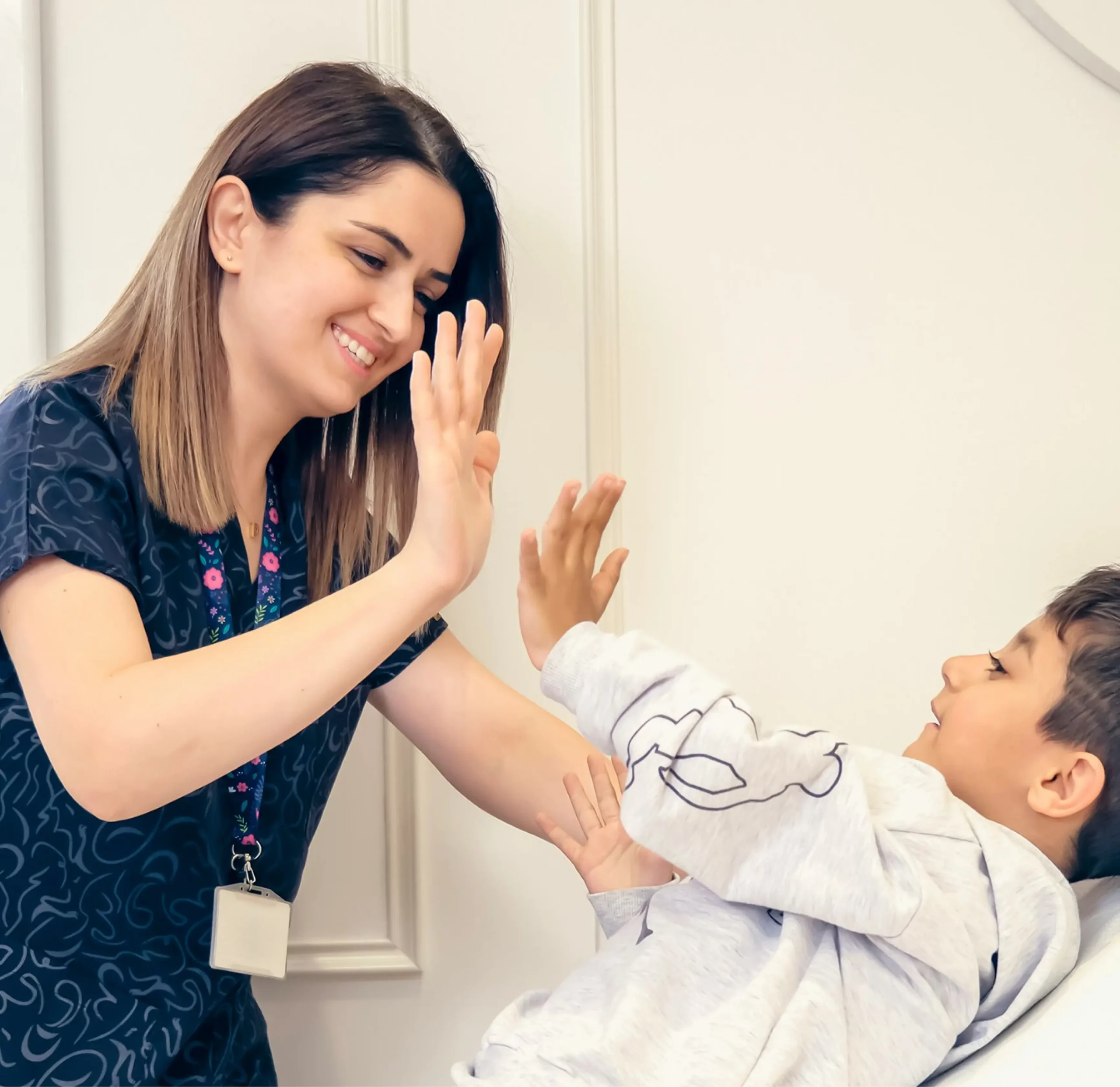 Woman high-fiving a child, possibly related to the "association.